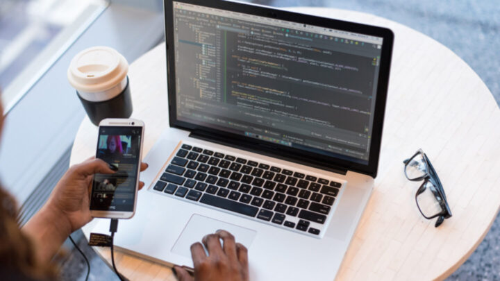 Computer portatile e telefono su una scrivania durante una conversazione di lavoro